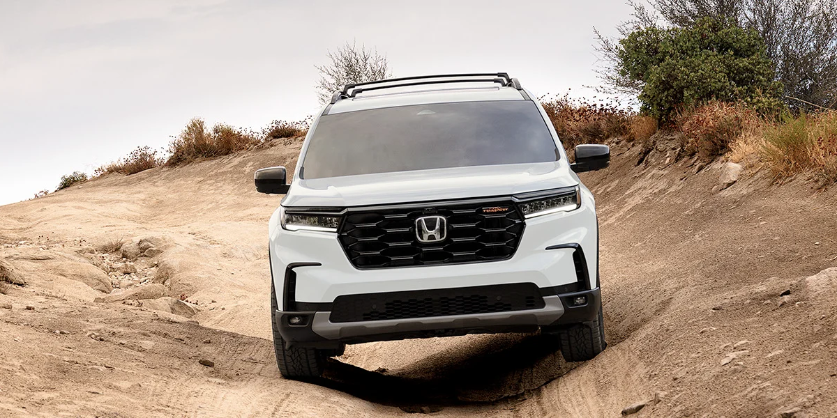 The 2024 Honda Pilot offroading on a dirt path